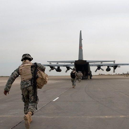 Warfighters with gear loading onto the back of a C-17 aircraft equipped with airborne technology